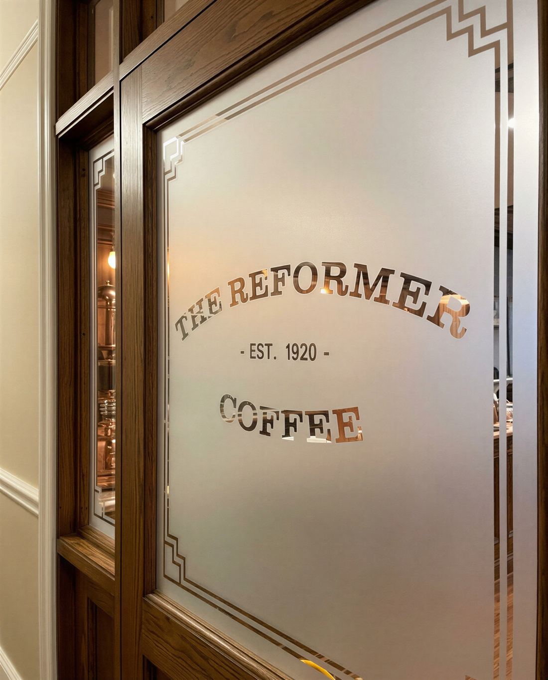 Coffee shop glass door with gold and frosted lettering