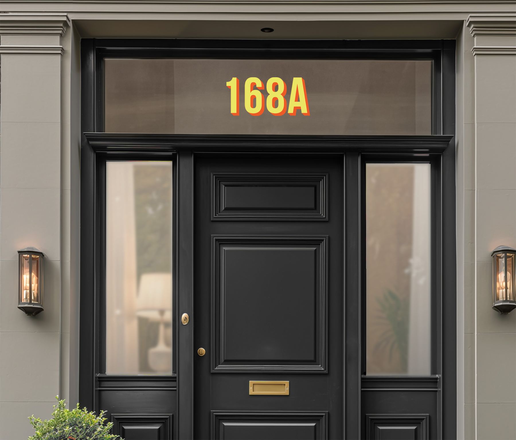Black front door with a chrome gold 168A house number on the fanlight
